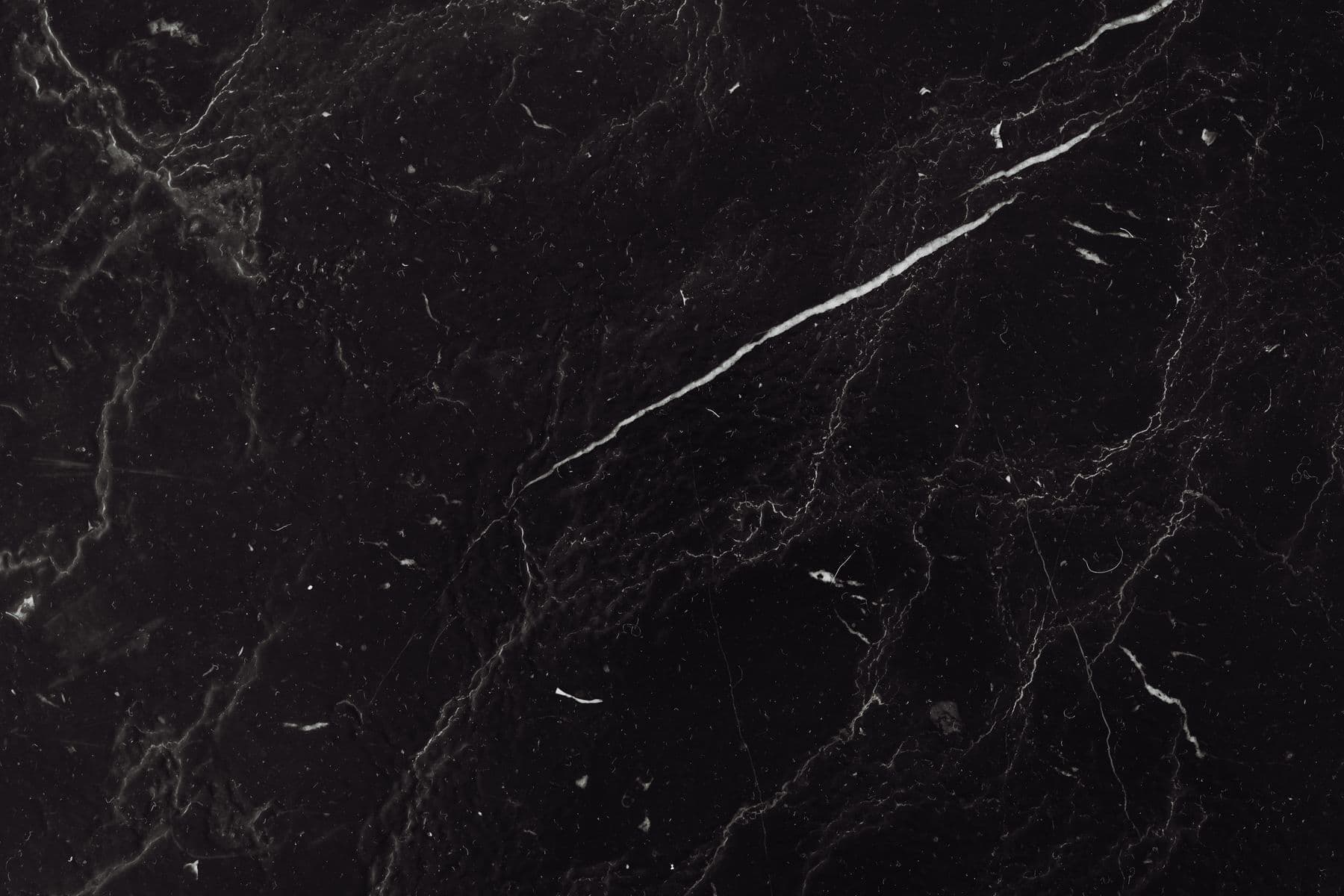 Close detail of black marble with fine natural veining.